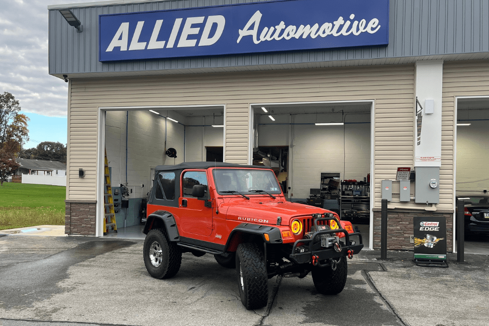 oil cooler leak, auto repair in Allentown, PA at Allied Automotive. Allied Automotive in front of the shop with a red Jeep Wrangler Rubicon parked outside.