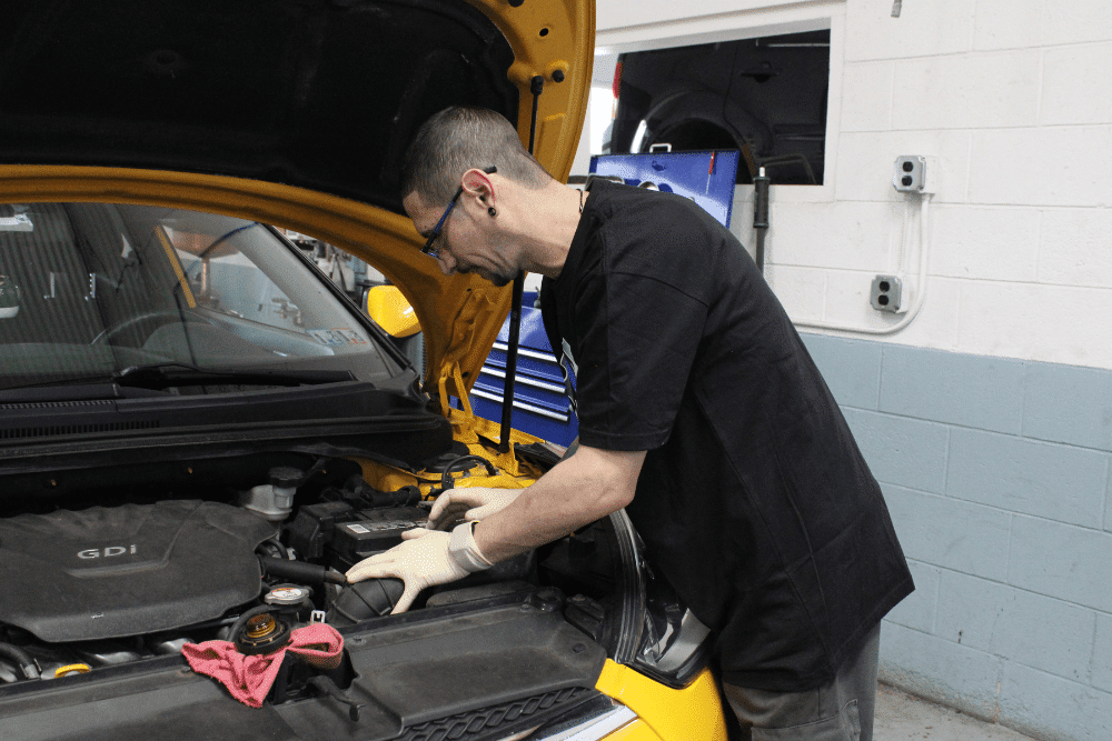 Car noises, auto repair in Allentown, PA by Allied Automotive. Image of a technician inspecting a vehicle’s engine with the hood open. Highlighting Allied Automotive’s commitment to reliable performance and precise engine diagnostics.