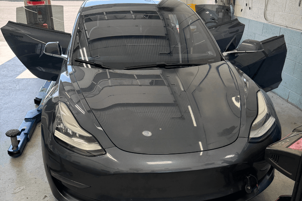 Tesla repair, auto repair in Allentown, PA by Allied Automotive. Image of a Tesla vehicle in a professional shop setting, highlighting advanced diagnostics, system checks, and specialized maintenance for modern electric vehicles.