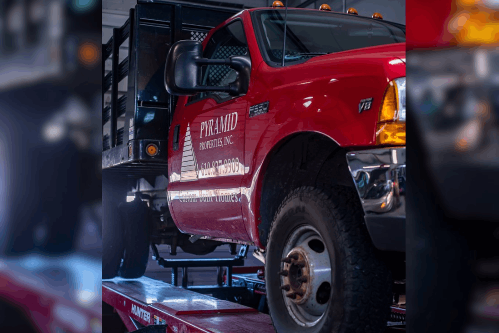 Fleet Services in Allentown, PA by Allied Automotive. Image of a commercial work truck on a lift, highlighting reliable diagnostics, maintenance, and repair services to keep fleet vehicles running efficiently and minimize downtime.