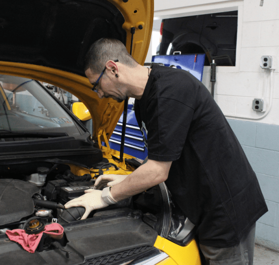 Car noises, auto repair in Allentown, PA by Allied Automotive. Image of a technician inspecting a vehicle’s engine with the hood open. Highlighting Allied Automotive’s commitment to reliable performance and precise engine diagnostics.