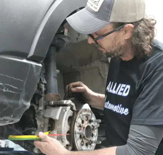 winter car maintenance, auto repair in Allentown, PA at Allied Automotive. Auto technician at Allied Automotive working on a vehicle's brake system.