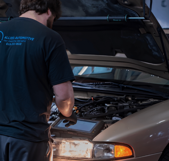 PA State Inspection in Allentown PA at Allied Automotive. Mechanic performing a PA state safety inspection using a diagnostic scan tool
